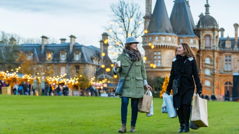 Visitors exploring the Christmas market at Waddesdon Manor, Buckinghamshire
